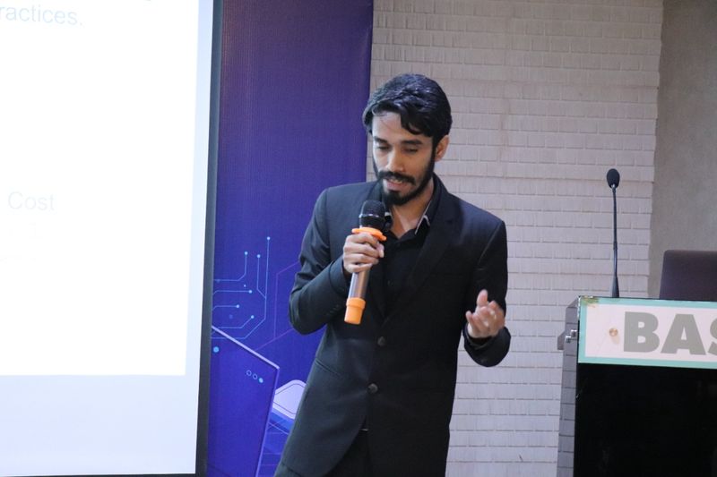Delwar Alam presenting slides at a conference