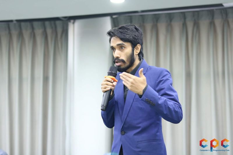 Delwar Alam giving a talk with a microphone